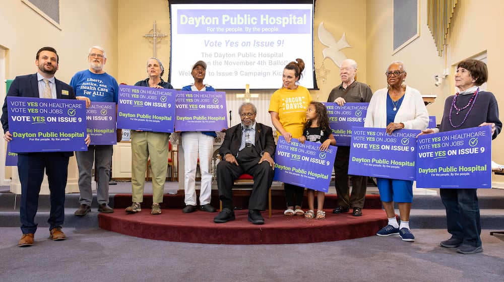 Volunteers in support of the passage of Issue 9 recite a chant urging voters to approve the levy during a meeting on Tuesday, Sept. 23 at College Hill Community Church in western Dayton. If passed, the levy would raise $2 million in support of a new public hospital in West Dayton. BRYANT BILLING / STAFF