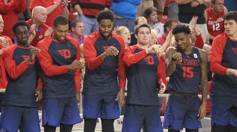 Dayton players (left to right) Jeremiah Bonsu, Trey Landers, Josh Cunningham, Joey Gruden and John Crosby react on the bench to a made free throw in overtime against Davidson on Friday, Feb. 24, 2017, at Belk Arena in Davidson, N.C. David Jablonski/Staff