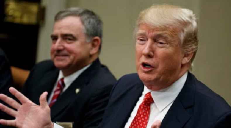 St. Charles, La. Parish Sheriff Greg Champagne, the president of the National Sheriffs Association listens at left as President Donald Trump speaks during a meeting with county sheriffs in the Roosevelt Room of the White House in Washington, Tuesday, Feb. 7, 2017. (AP Photo/Evan Vucci)