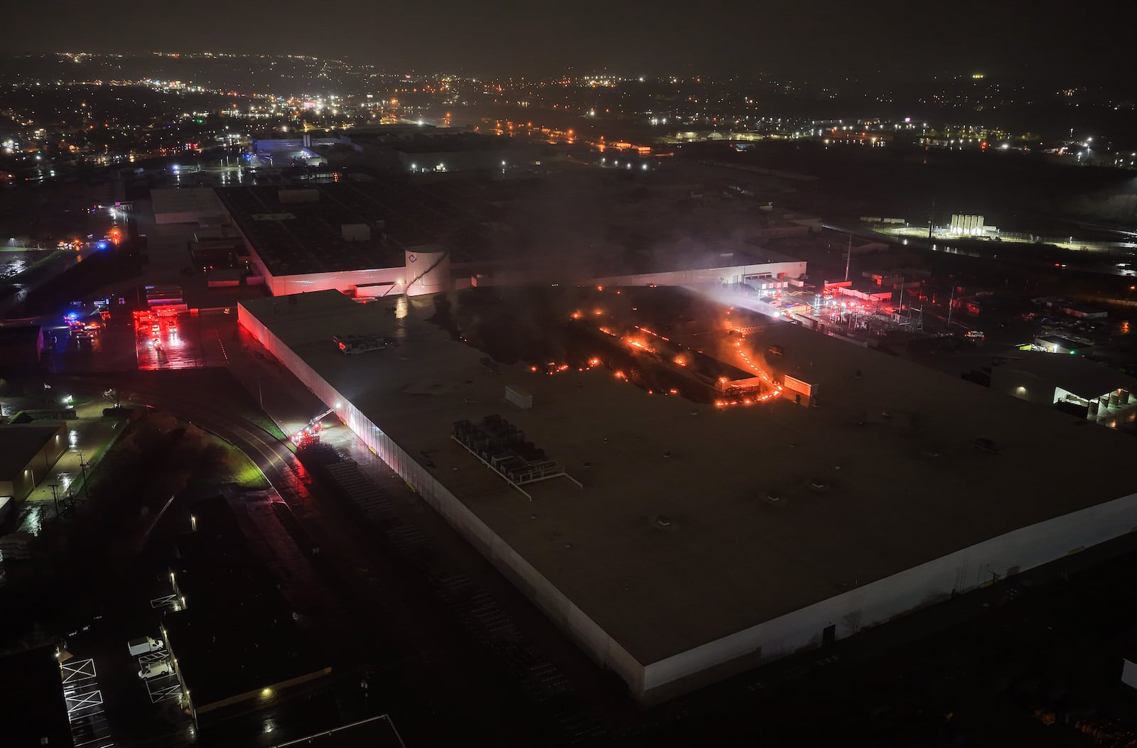 Flames from the Fuyao Glass America fire could be seen three hours after the fire started around 8:30 p.m. Sunday, March 22, 2026 in Moraine. Drone photos by Nick Graham / Staff