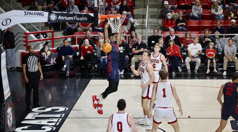 Dayton's DaRon Holmes II dunks against Davidson on Saturday, Dec. 31, 2022, at Belk Arena in Davidson, N.C. David Jablonski/Staff