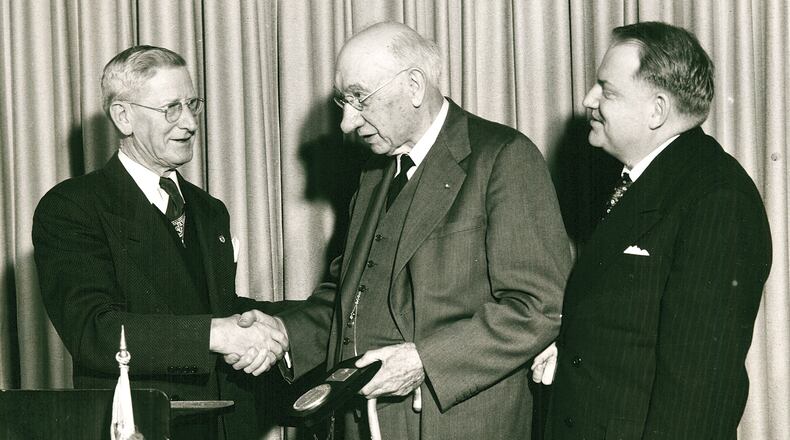 This photo from January 15, 1952 shows 4-H founder A.B. Graham (center) receiving the Eagles’ International Civic Service Award from Eagles President William P. Wetherald during a luncheon honoring Graham and the 50th anniversary of the founding of 4-H, held at the Shawnee Hotel. At the time, the award had only been given to thirteen others, including Eleanor Roosevelt, Babe Ruth, President Truman, General Eisenhower, and J. Edgar Hoover. Earlier that day, Graham was honored during a morning ceremony at Springfield High School when the 50th anniversary 4-H stamp was introduced by Assistant Postmaster General, Osborn A. Pearson (right). Graham was the first to purchase a sheet of the special stamps and hundreds lined up at the post office for the collectible item. All 4-H students in the county were excused from school to attend and more than 60 clubs leaders from all over Ohio were in attendance. PHOTO COURTESY OF THE CLARK COUNTY HISTORICAL SOCIETY