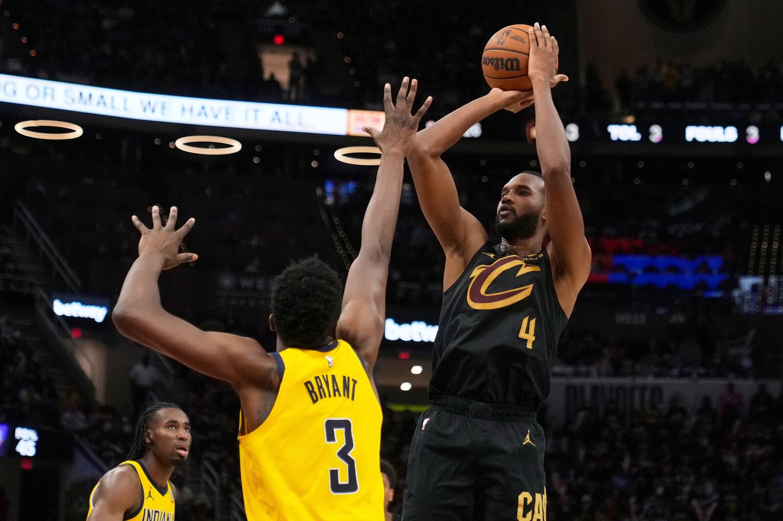 Cleveland Cavaliers forward Evan Mobley, right, shoots as Indiana Pacers center Thomas Bryant defends during the second half in Game 5 of an Eastern Conference semifinal NBA basketball playoff Tuesday, May 13, 2025, in Cleveland. (AP Photo/Sue Ogrocki)