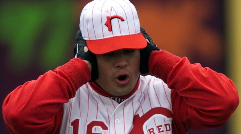 Rockford Reds third baseman Brandon Larsen , a '97 first round pick, cups his ears in the frigid air during warm-ups before the home opener.