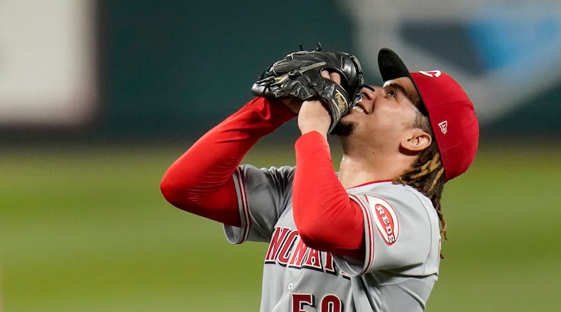 Cincinnati Reds starting pitcher Luis Castillo celebrates after throwing a complete baseball game against the St. Louis Cardinals Friday, Sept. 11, 2020, in St. Louis. The Reds won 3-1. (AP Photo/Jeff Roberson)