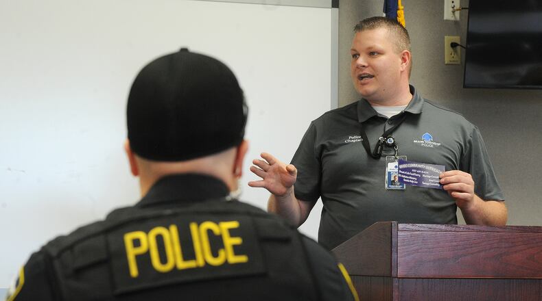 The Rev. Patrick Dell'Aria, pastor of Moraine Heights Baptist Church and chaplain for Miami Twp. Police Department, talks with police officers, Wednesday, May 12, 2021. MARSHALL GORBY/STAFF
