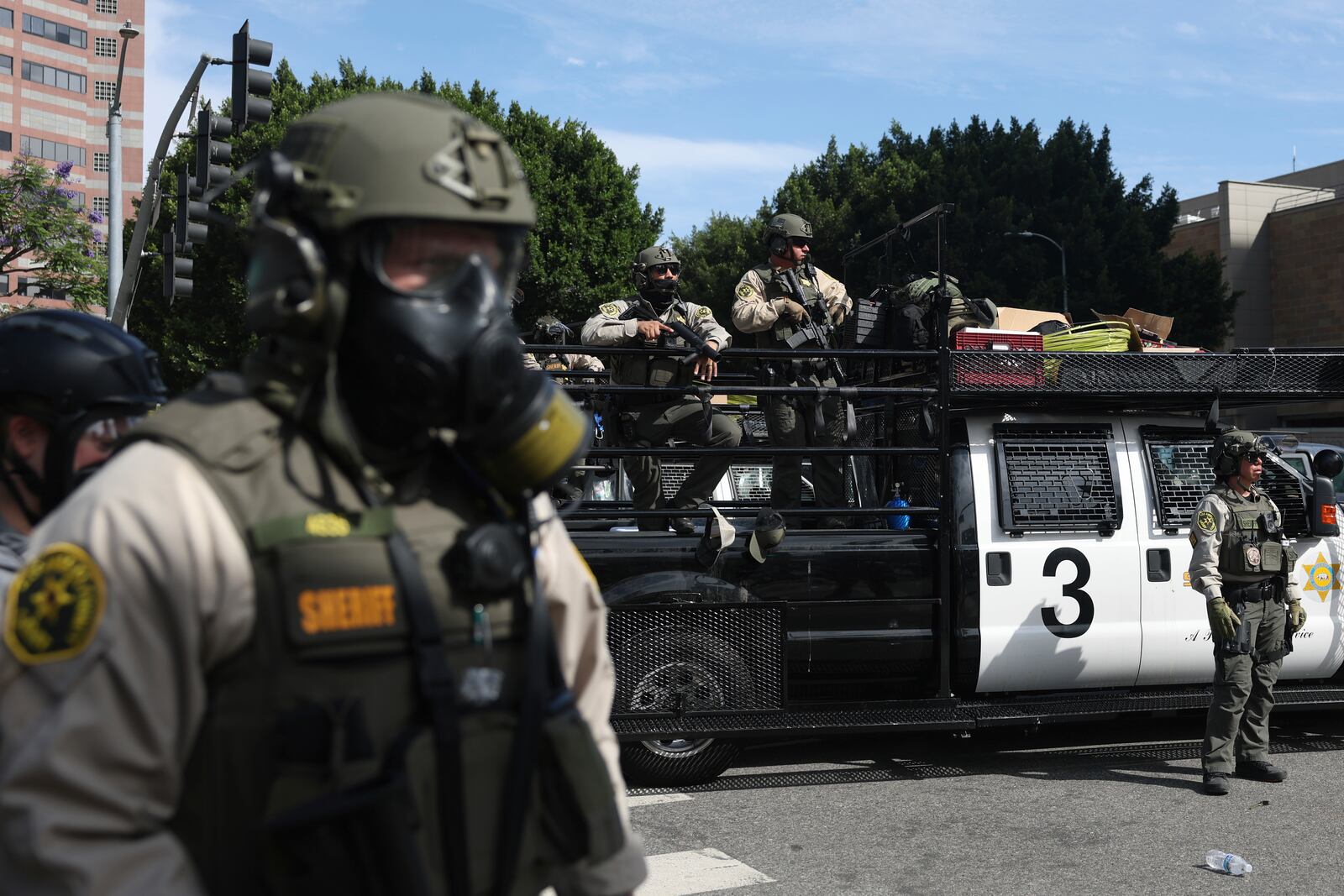 FILE - Law enforcement officers stand guard during a protest June 14, 2025, in Los Angeles. (AP Photo/Ethan Swope, File)