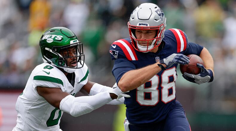 New England Patriots tight end Mike Gesicki (88) carries the ball against New York Jets safety Adrian Amos (0) during the first quarter of an NFL football game, Sunday, Sept. 24, 2023, in East Rutherford, N.J. (AP Photo/Adam Hunger)
