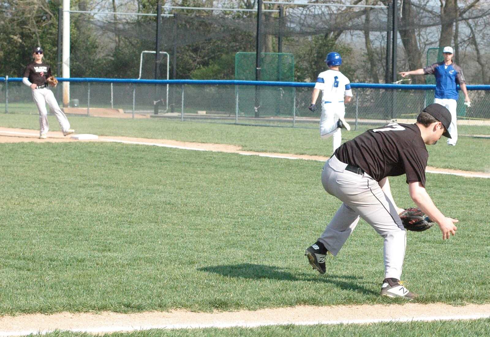Franklin pitcher Tytus Tussey fields a bunt as Brookville’s Ben Smith sprints toward first base Tuesday during a Southwestern Buckeye League Southwestern Division baseball game at Brookville. The host Blue Devils won 5-4. RICK CASSANO/STAFF