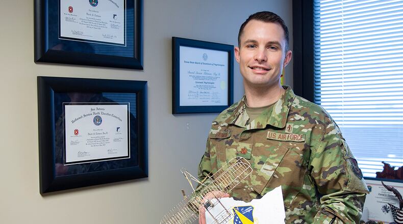 Maj. David Tubman stands in his office with the 88th Air Base Wing’s 2020 Field Grade Officer of the Year Award for his work in the 88th Medical Group’s Mental Health Clinic. U.S. AIR FORCE PHOTO/WESLEY FARNSWORTH