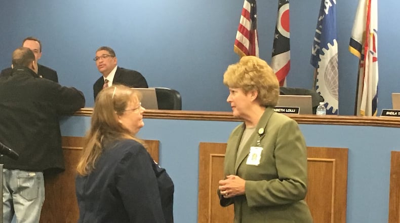 Dayton Public Schools Superintendent Elizabeth Lolli (right) talks to DPS Human Resources Director Judith Spurlock at a March 2018 school board meeting. The district is making significant changes to administrative staff this fall. JEREMY P. KELLEY / STAFF