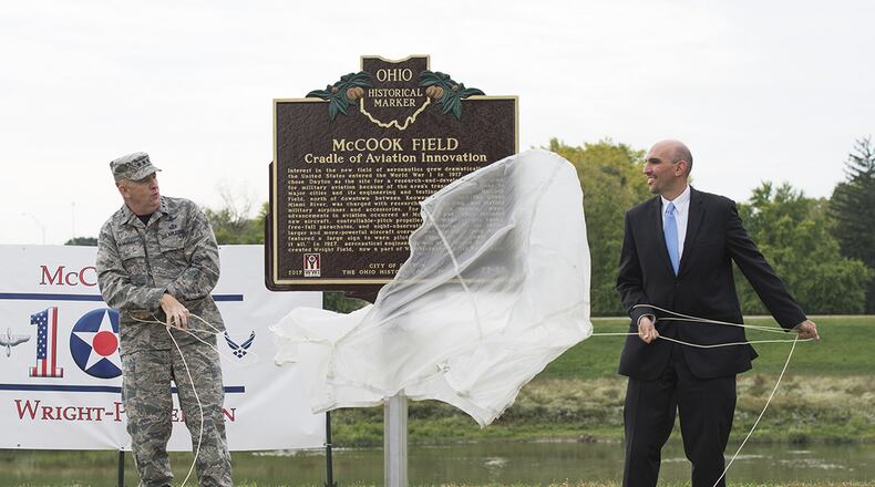 Lt. Gen. Robert D. McMurry Jr., commander, Air Force Life Cycle Management Center, Wright-Patterson Air Force Base, and Matt Joseph, City of Dayton commissioner, unveil the new McCook Field historical marker during the McCook Field Centennial Ceremony in Dayton Oct. 6, celebrating a century of aerospace innovation. In 1917, the U.S. Army Signal Corps Airplane Engineering Department opened new facilities at McCook Field. It played a key role in the early rearing of the nation’s aviation industry and earned the name, “Cradle of Aviation.” (U.S. Air Force photo/Wesley Farnsworth)