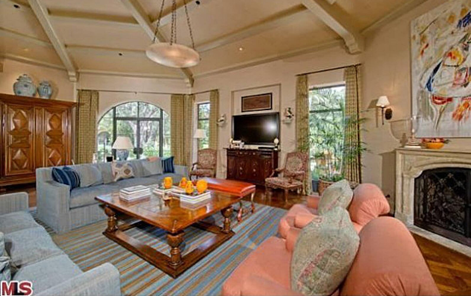 Mediterranean-style home features pool, spa