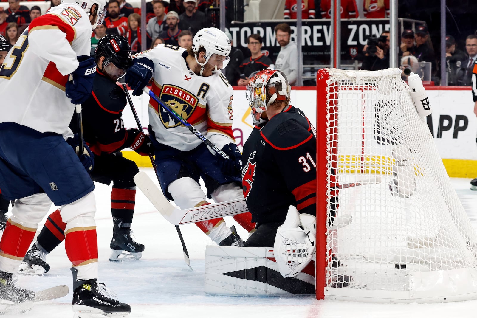 Florida Panthers' Matthew Tkachuk (19) slips the puck past Carolina Hurricanes goaltender Frederik Andersen (31) for a goal during the first period of Game 2 of the NHL hockey Stanley Cup Eastern Conference finals in Raleigh, N.C., Thursday, May 22, 2025. (AP Photo/Karl DeBlaker)
