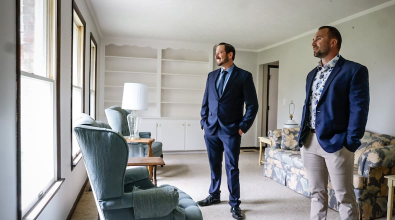 Home Experts Realty agents, Joel Booher, left and Chad Nabors walk through a home in Vandalia that is for sale. The home has been on the market for five days and has had multiple offers. JIM NOELKER/STAFF