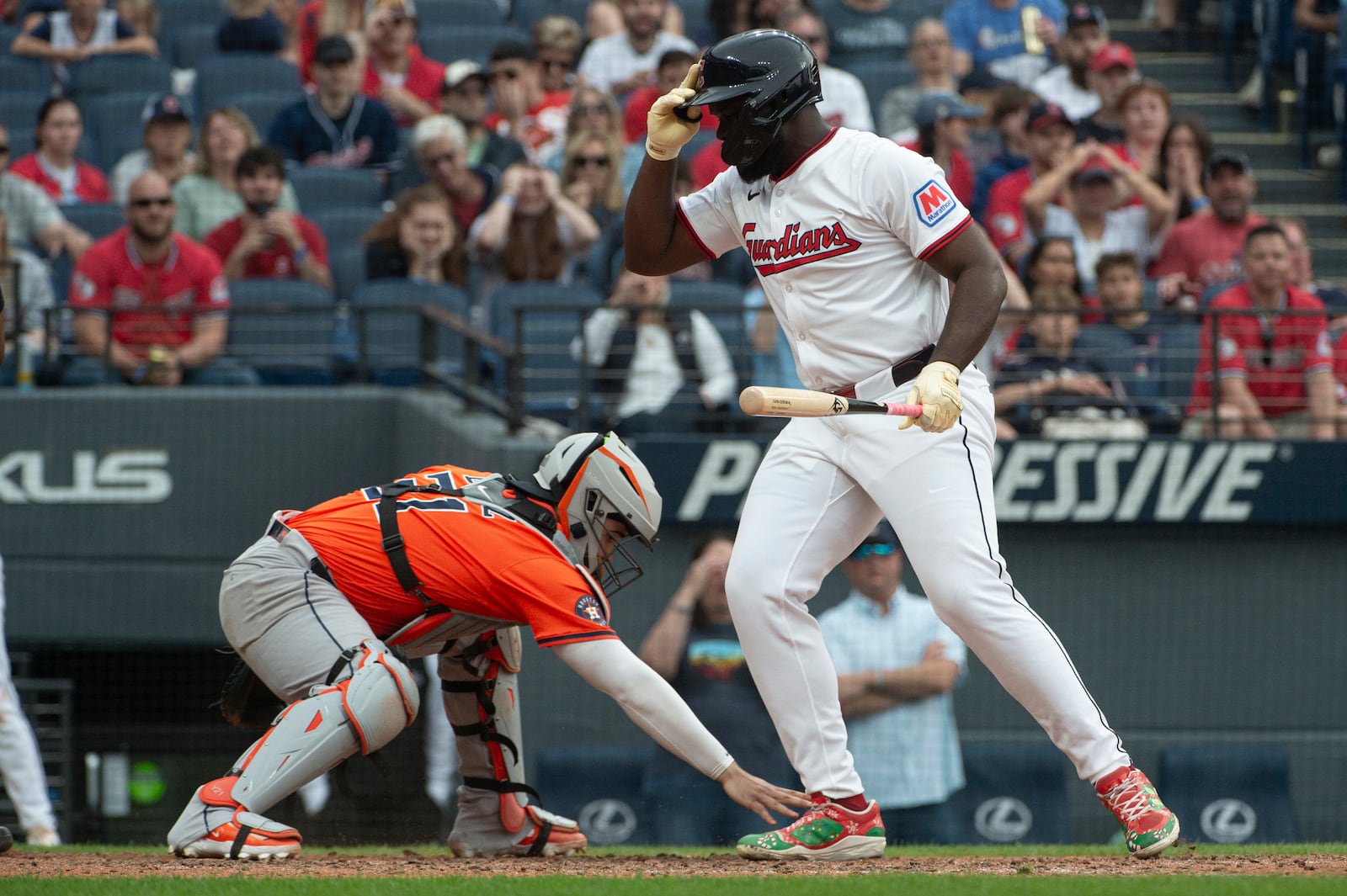 Cleveland Guardians' Jhonkensy Noel, left, makes the final out as Houston Astros' Yainer Diaz, left, reaches for the ball at the end of the 10th inning of a baseball game, Saturday June 7, 2025, in Cleveland. (AP Photo/Phil Long)