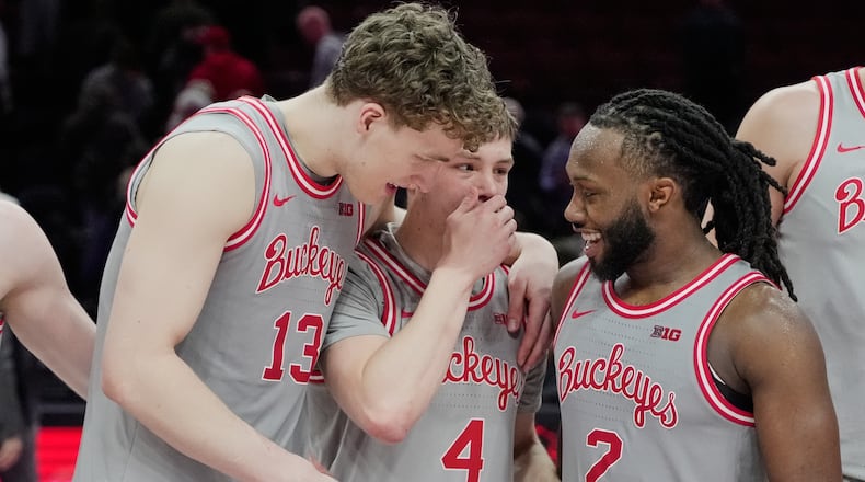 Ohio State guard Bruce Thornton (2) celebrates with teammates Christoph Tilly (13) and Gabe Cupps (4) after Ohio State defeated Wisconsin in an NCAA college basketball game Tuesday, Feb. 17, 2026, in Columbus, Ohio. (AP Photo/Sue Ogrocki)
