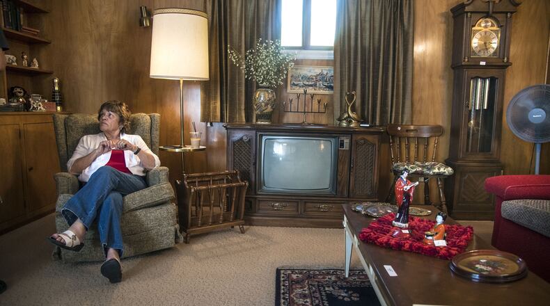 Smooth Transitions co-owner DeAnne Wilfong says items like an old console TV the wooden magazine rack are hard to move. (Dan Pelle/The Spokesman-Review/TNS)