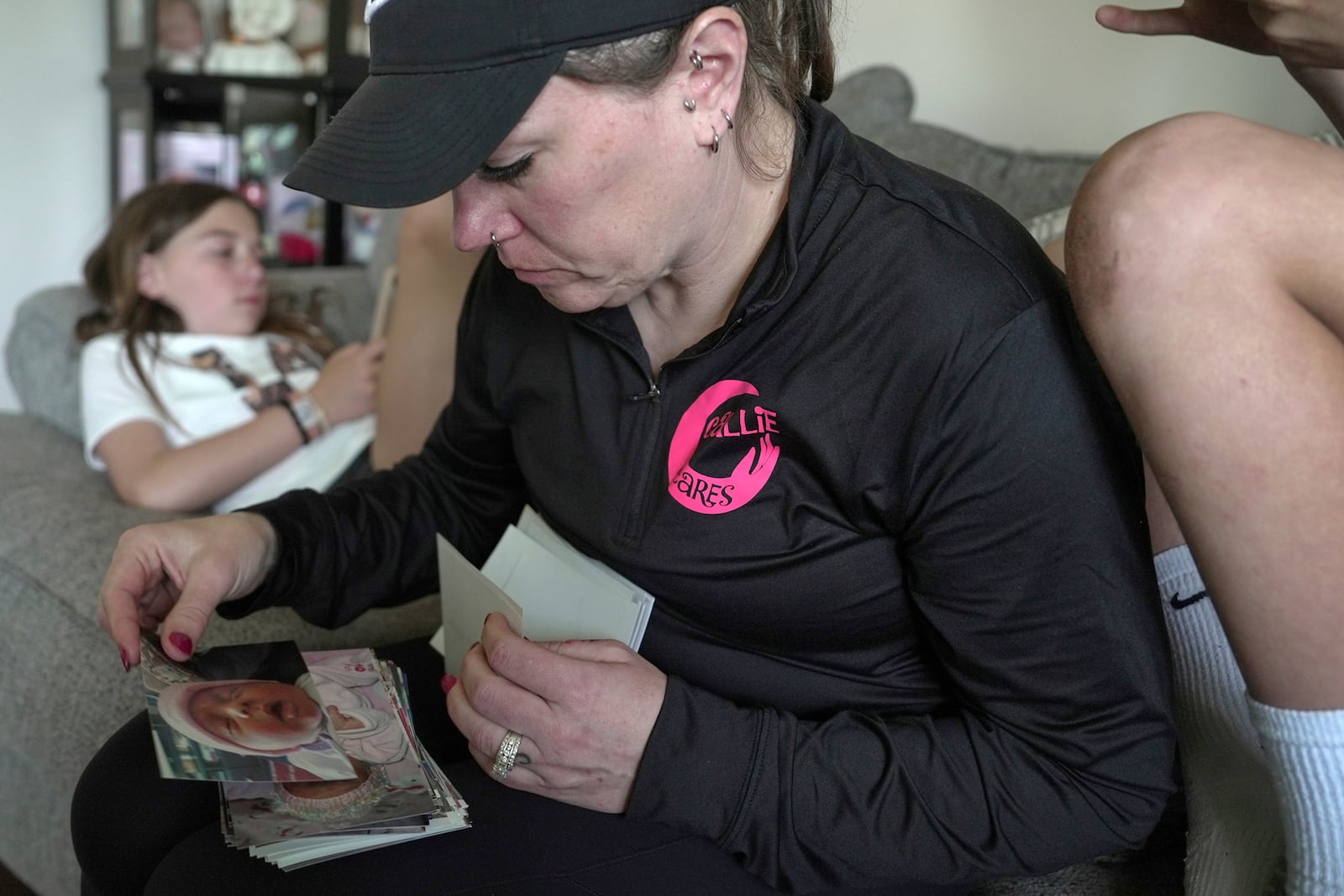 Katie Van Tornhout looks through photos of her late daughter, Callie, at home in Lakeville, Ind., on May 7, 2025. (AP Photo/Shelby Lum)