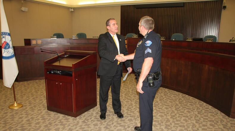 City Manager John Crusey congratulations Officer Lawson