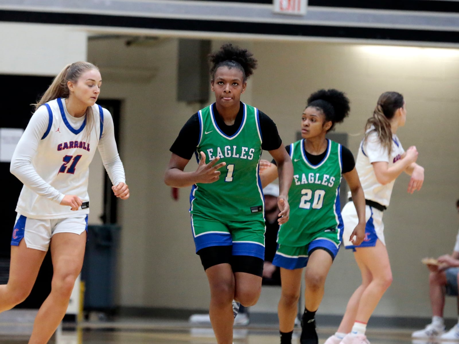Chaminade Julienne freshman Ja'Kyiah Cook celebrates holding up three fingers after her only shot from beyond the arc during a Division III regional final game Saturday, March 7, 2026, at Lakota East. CJ won 49-45. STEVEN WRIGHT / STAFF