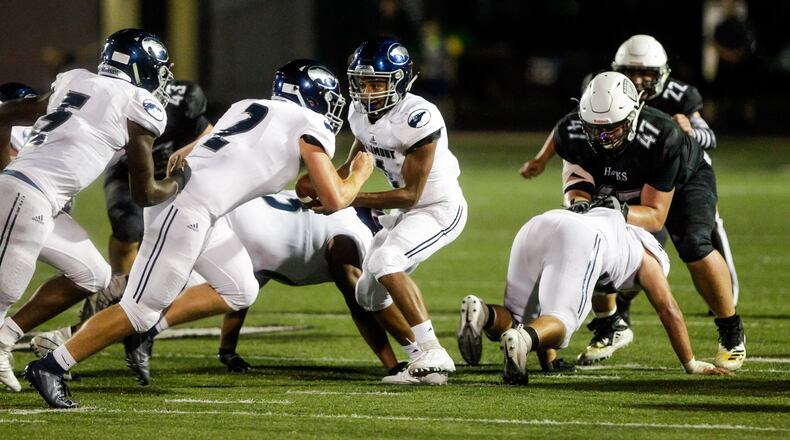 Fairmont quarteback Male’k Hillon hands off the ball to Elijah Swallow during their game against Lakota East Friday, Sept. 6 at Lakota East High School. Hillon rushed for a pair of TDs and pass for another in Fairmont’s win over Centerville on Friday night . NICK GRAHAM/STAFF