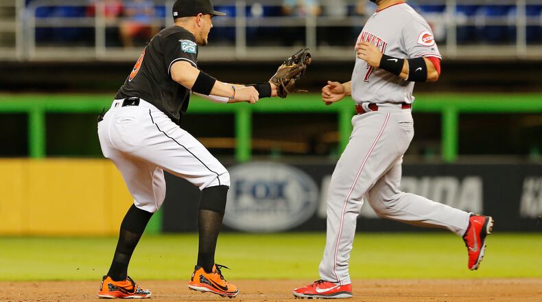MIAMI, FL - SEPTEMBER 22: Eugenio Suarez #7 of the Cincinnati Reds is tagged out stealing in the second inning by shortstop Miguel Rojas #19 of the Miami Marlins at Marlins Park on September 22, 2018 in Miami, Florida. (Photo by Joe Skipper/Getty Images)