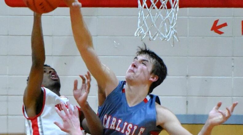 Carlisle’s Justin Flor challenges a shot by Northridge’s Javoni Hill during their game Feb. 17 at Northridge. NICK GRAHAM/STAFF