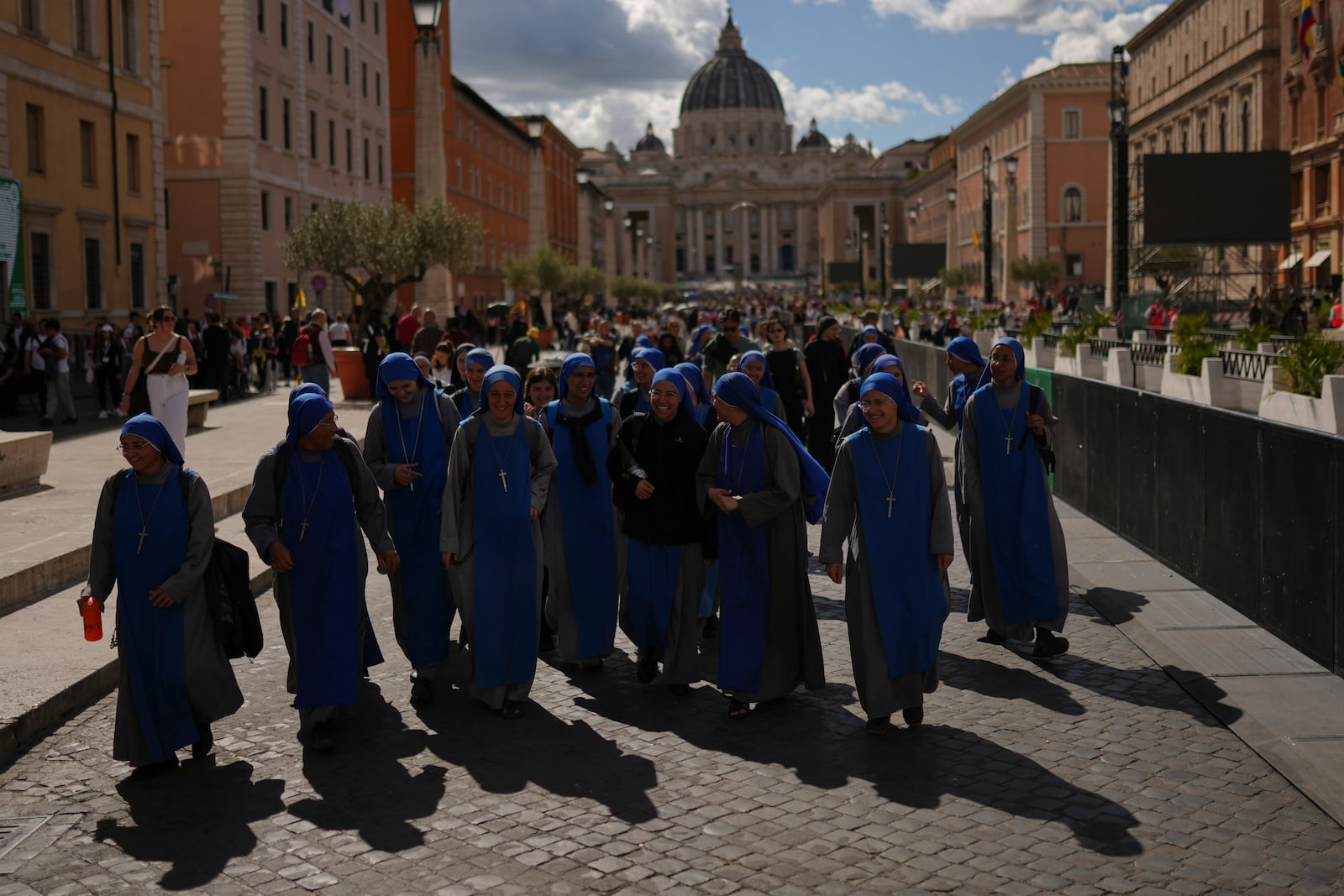 Nuns walk away from St. Peter's Basilica where Pope Francis is lying in state, at the Vatican, Friday, April 25, 2025. (AP Photo/Francisco Seco)