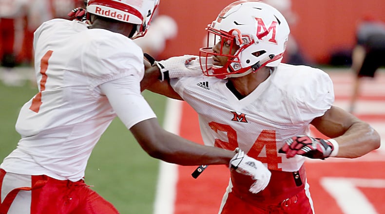Miami Redhawks defensive back Heath Harding (right) covers teammate Cedric Asseh during practice in Oxford on Wednesday. E.L. HUBBARD/CONTRIBUTED