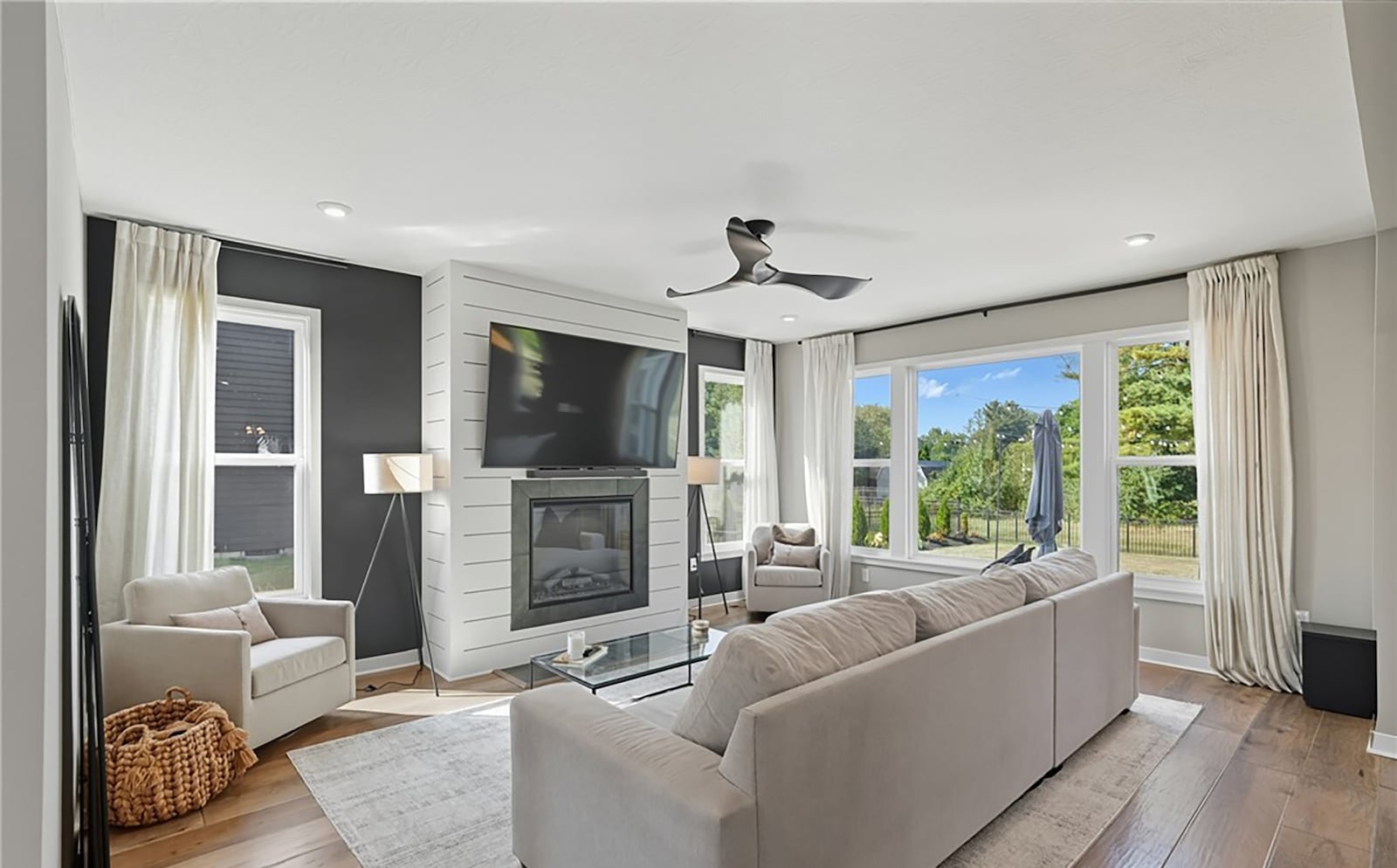 The living room has hardwood flooring, a gas fireplace, ceiling fan and recessed lighting. CONTRIBUTED