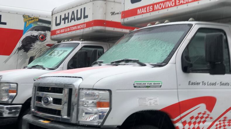 U-Haul moving trucks parked on a lot on East Third Street in Dayton. CORNELIUS FROLIK / STAFF