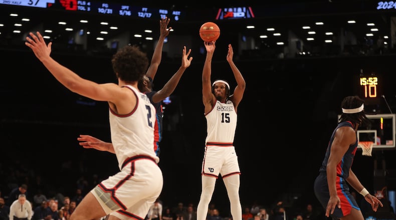 Dayton's DaRon Holmes II shoots a 3-pointer against Duquesne in the Atlantic 10 Conference tournament quarterfinals on Thursday, March 14, 2024, at the Barclays Center in Brooklyn, N.Y. David Jablonski/Staff