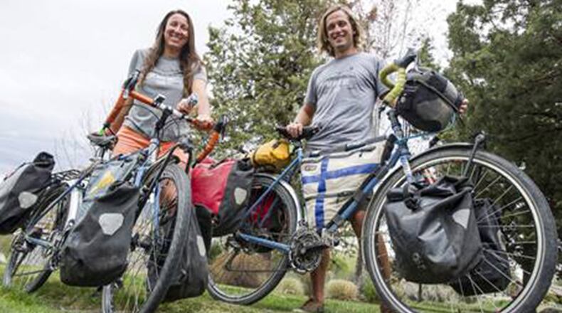 Kristen and Ville Jokinen stand by their bikes near their Bend home on last week. The couple recently completed a 20-month cycling journey together that logged more than18,000 miles from Alaska to Argentina. (Ryan Brennecke/Bulletin Bend/TNS)