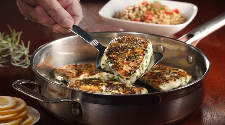 Halibut is coated with herbs before searing in a skillet, then the pan is transferred to the oven to finish cooking the fish without drying it out. (Abel Uribe/Chicago Tribune/TNS)