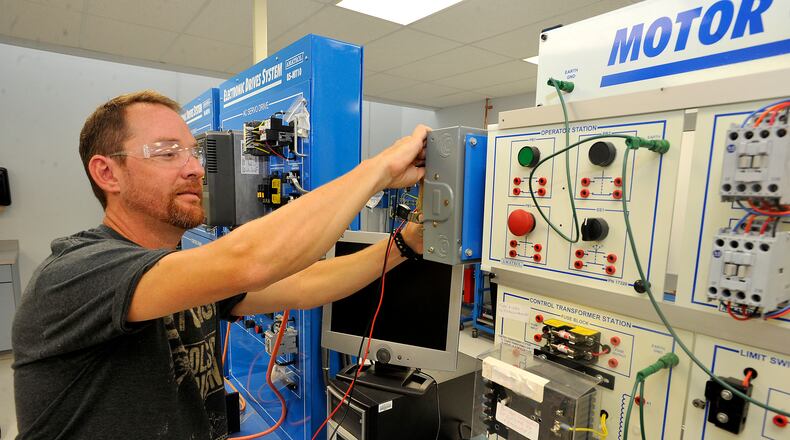 Gabriel Reed, a student at Clark State, works in a manufacturing lab at the Leffel Lane campus. Bill Lackey/Staff