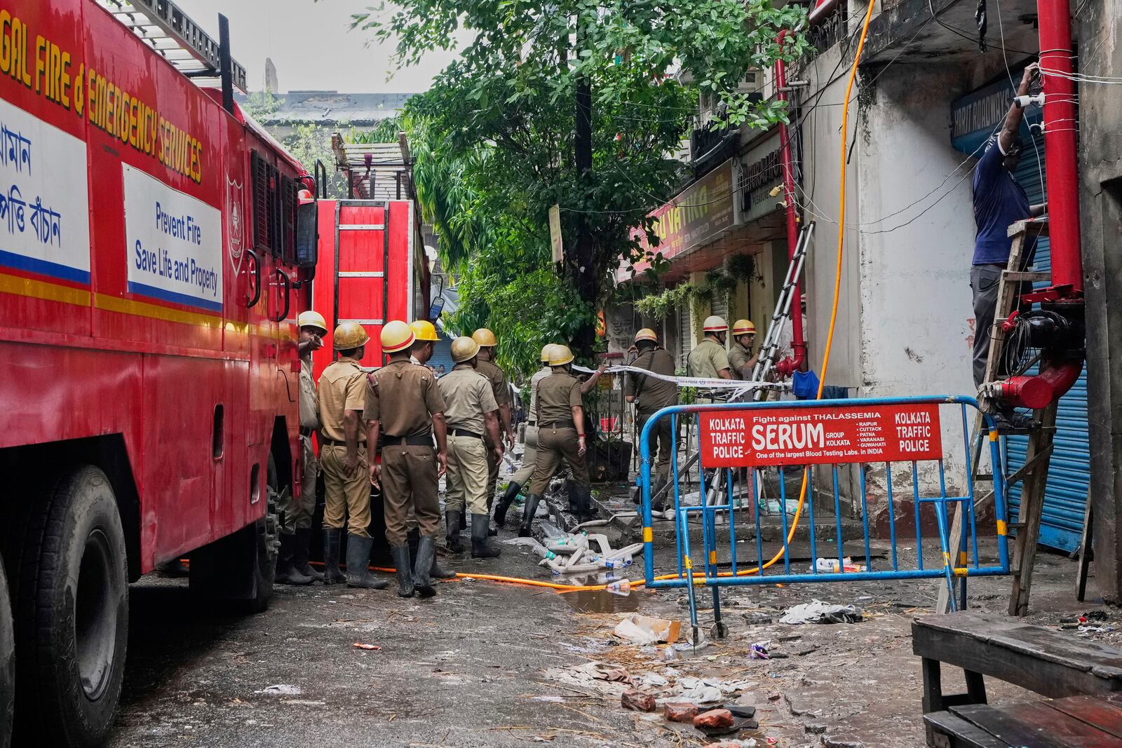Firefighters inspect a hotel building which caught fire on Tuesday resulting in several deaths, in Kolkata, India, Wednesday, April 30, 2025. (AP Photo/Bikas Das)