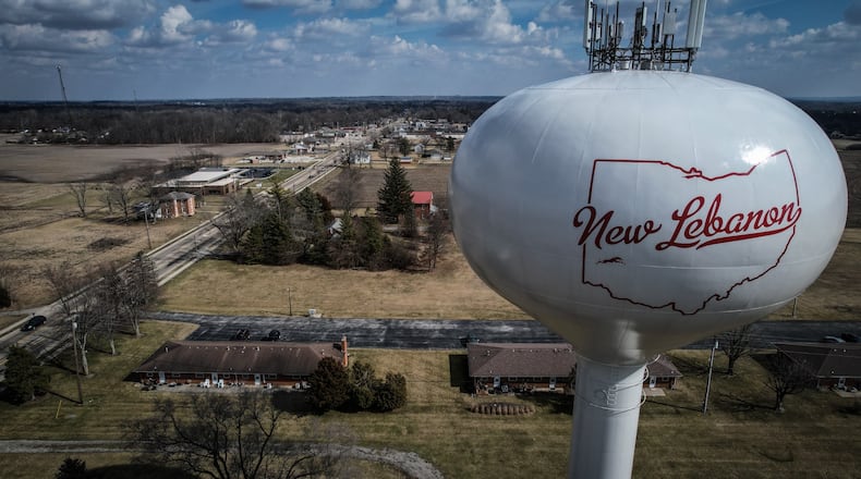 The water tower stands on the west side of the village of New Lebanon Ohio. The village council recently put 5 village leaders on leave. Jim Noelker/Staff