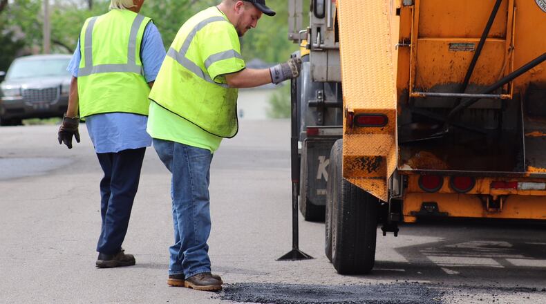 City of Dayton public workers fill a pothole near EastView Avenue in Dayton. JARED THRUSH/STAFF WRITER