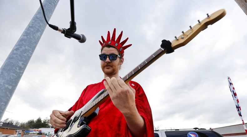 Chase Watkins plays guitar at the corner of Cincinnati Dayton Road and Tylersville Road April 12 in front of Liberty Tax service in West Chester Twp. Today, April 18, is the deadline to file taxes or request an extension. NICK GRAHAM/STAFF