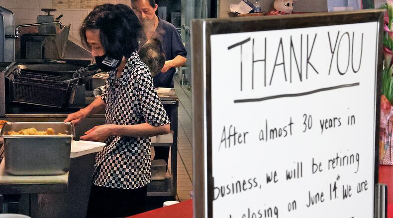Mark Pi Express owners Kim Hua and his wife Tule cook for the lunch crowd at their restaurant in the Upper Valley Mall. Kim and Tule have owned the restaurant for 28 years and plan to retire when their restaurant closes on Monday. BILL LACKEY/STAFF