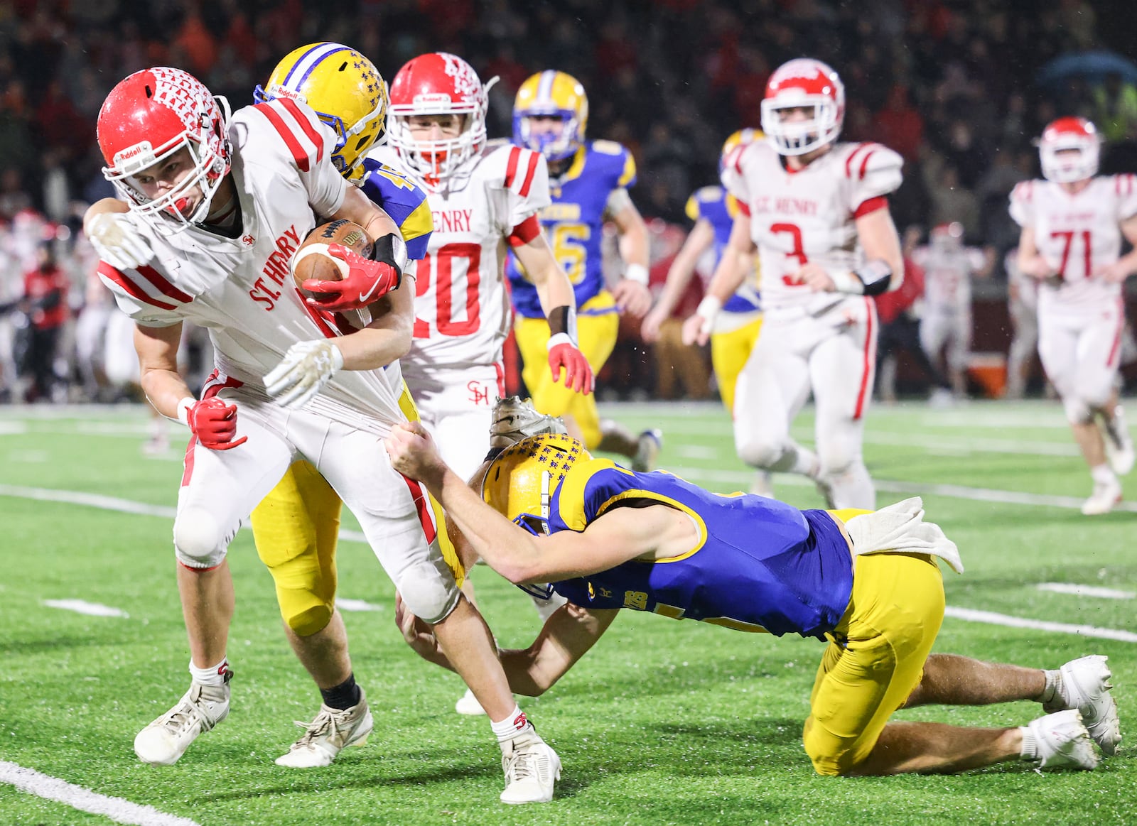 St. Henry senior receiver Jack Huelsman fights for extra yardage as Marion Local's Brayden Mescher during the Division VII, Region 28 championship on Friday, Nov. 21 at Mercy Health/Wapak VFW Field in Wapakoneta. BRYANT BILLING/STAFF