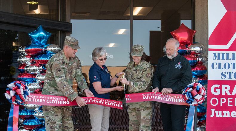 Col. Sirena Morris, 88th Mission Support Group commander, cuts the ribbon on the new location of Military Clothing Sales during its reopening ceremony June 30 at Wright-Patterson Air Force Base. She was joined by installation leaders and Army & Air Force Exchange Service managers. The store was relocated to provide ease of access for Airmen and retirees looking to purchase military clothing items. U.S. AIR FORCE PHOTO/STAFF SGT. MIKALEY KLINE