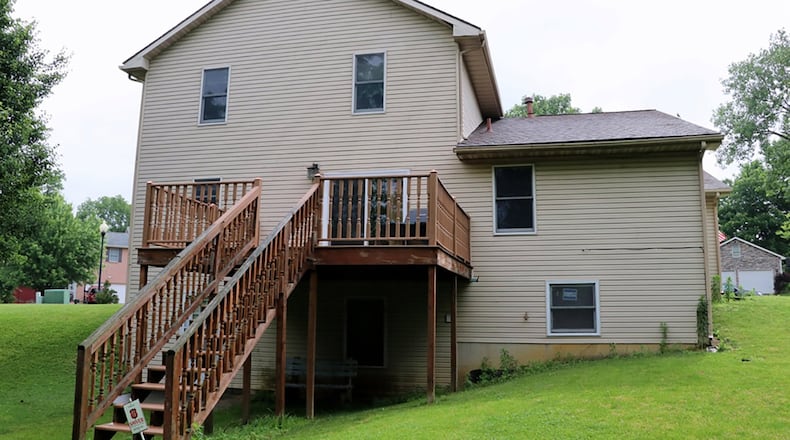 Patios doors off the breakfast room open to a balcony wooden deck. The basement has been finished into a recreation room with a daylight window and a door that opens to the semi-private back yard. Three upstairs bedrooms have walk-in closets.