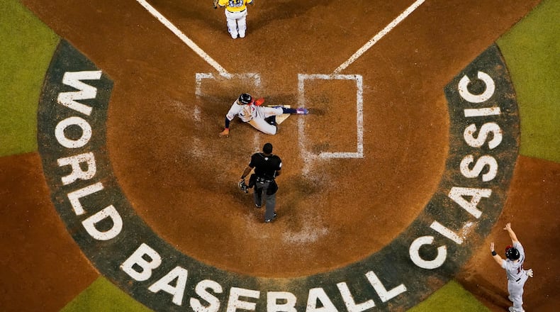 FILE - United States' Mookie Betts, center, scores against Colombia on Mike Trout's two-run single during the fifth inning of a World Baseball Classic game in Phoenix, Wednesday, March 15, 2023. (AP Photo/Godofredo A. Vásquez, File)