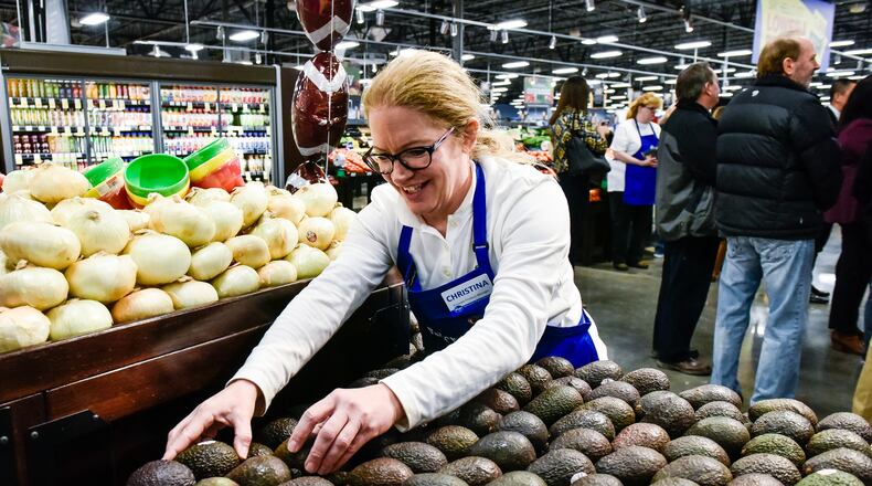 Christina Burkart organizes produce at the new Kroger Marketplace at Crossings of Beckett on Princeton Glendale Road near Tylersville Road in West Chester Township. NICK GRAHAM/STAFF