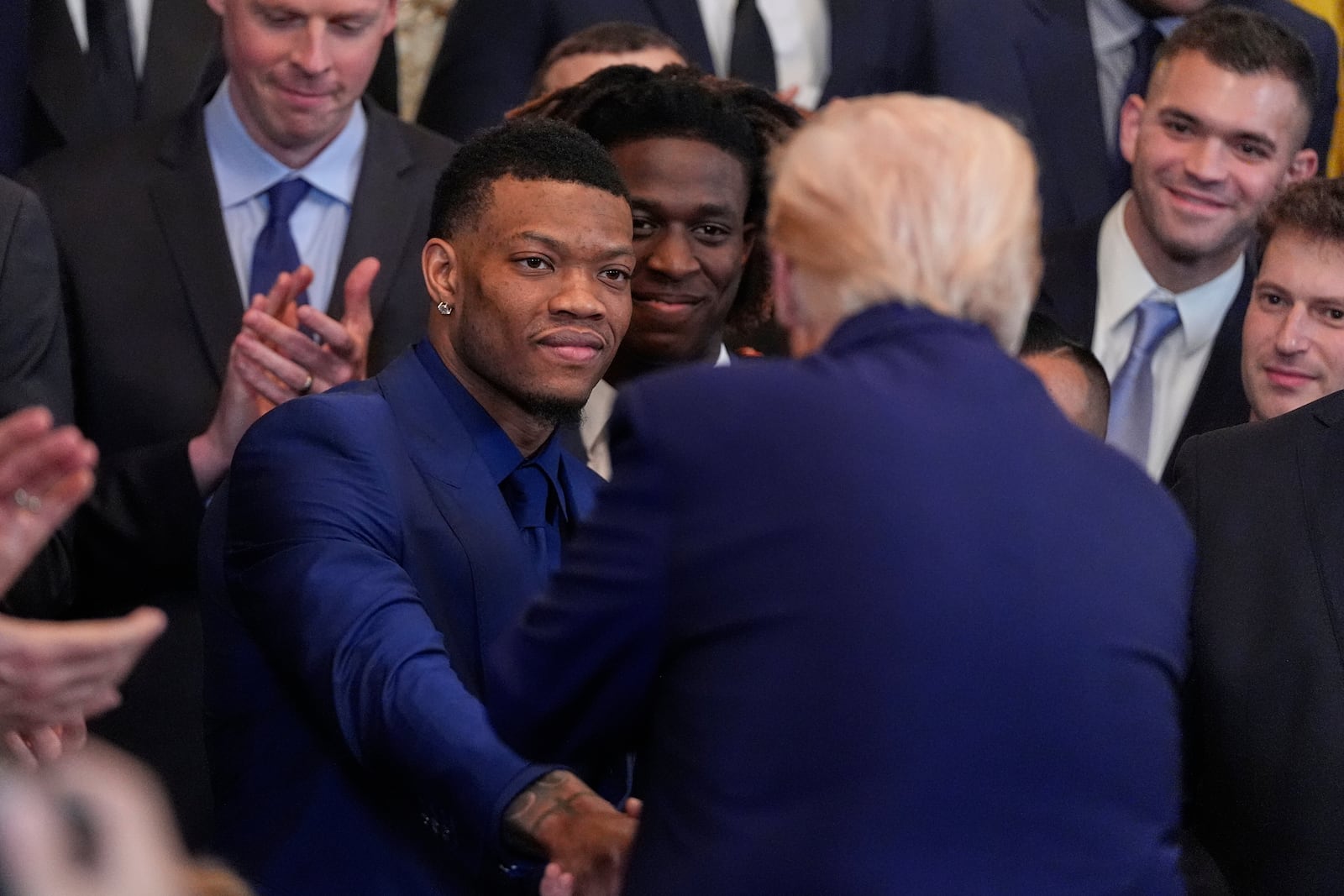 President Donald Trump shakes hands with Alijah Martin as he hosts the 2025 NCAA Champion, University of Florida men's basketball team in the East Room of the White House, Wednesday, May 21, 2025, in Washington. (AP Photo/Julia Demaree Nikhinson)