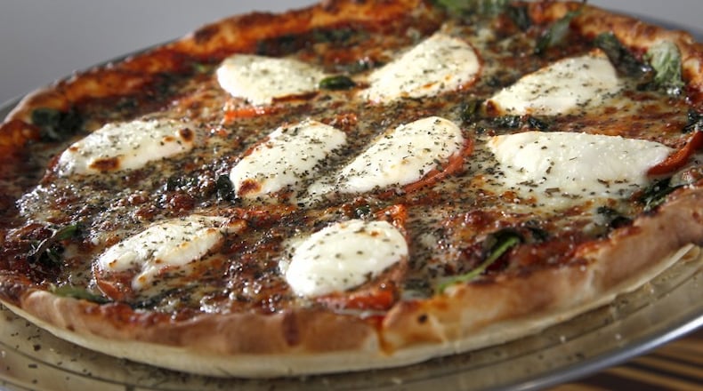 Gionino's Pizzeria makes a 'Caprese pizza' with signature pizza sauce on a thin crust with fresh mozzerella and provolone cheese, spinach, basin , tomatoes and parmesan cheese. The pizzeria opened its first Dayton location at 1528 E. Third St. The franchise, owned by Tony Clark, has about 45 locations between Cleveland and Canton, with a Columbus location as well. LISA POWELL / STAFF