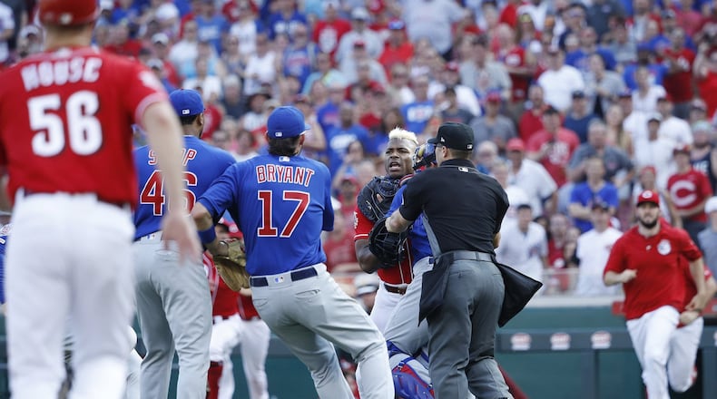 Yasiel Puig of the Cincinnati Reds is restrained after being hit by a pitch from Pedro Strop of the Chicago Cubs in the eighth inning at Great American Ball Park in Cincinnati on Saturday, June 29, 2019. The Cubs won, 6-0. (Joe Robbins/Getty Images) **FOR USE WITH THIS STORY ONLY**
