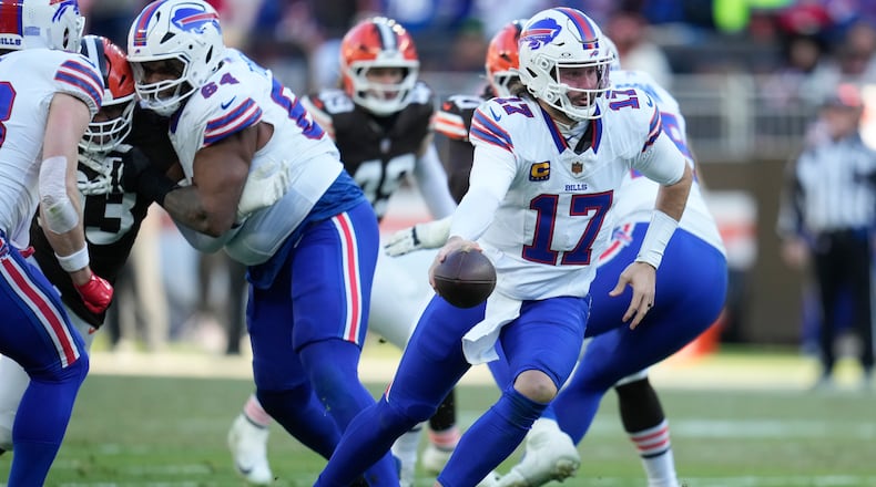 Buffalo Bills quarterback Josh Allen (17) hands off against the Buffalo Bills during the second half of an NFL football game in Cleveland, Sunday, Dec. 21, 2025. (AP Photo/Sue Ogrocki)
